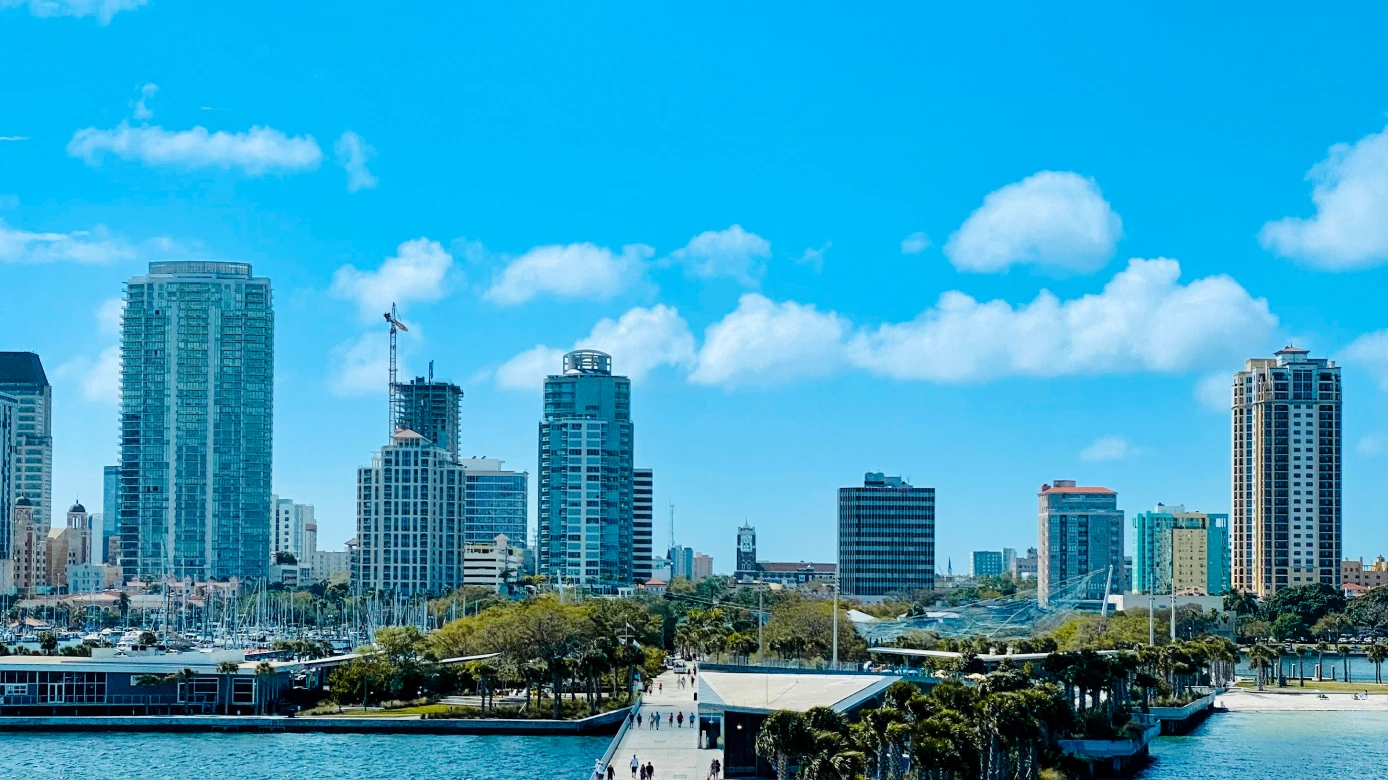 St. Petersburg, Florida skyline view with high-rise buildings and a pier extending into the water.