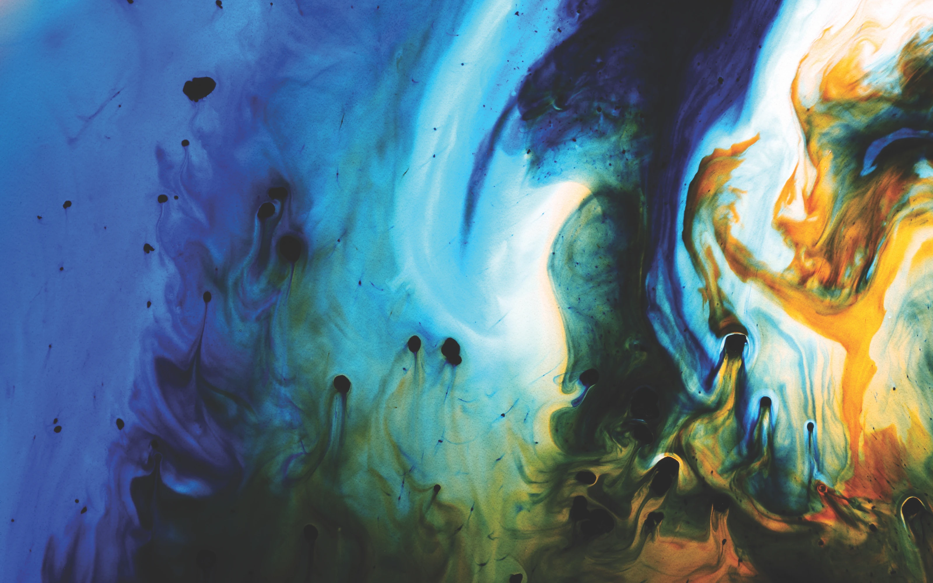 Abstract art with swirling blue, yellow, green, and black colors blending together in a fluid, paint-like pattern.