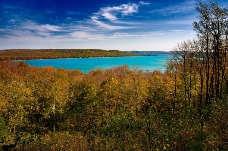 Blue Lake surrounded by trees with changing leaf colors