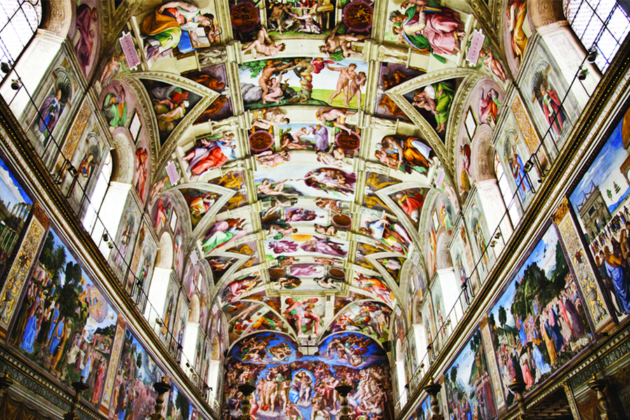 Ceiling and walls of the Sistine Chapel covered in colorful frescoes and detailed religious scenes.