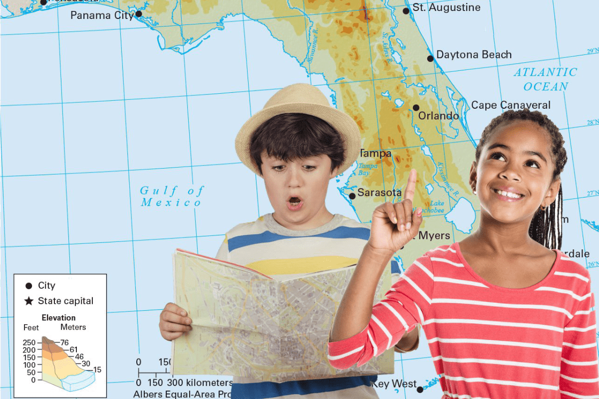 Two kids stand in front of a Florida map; one reads a map, the other smiles and points upward.