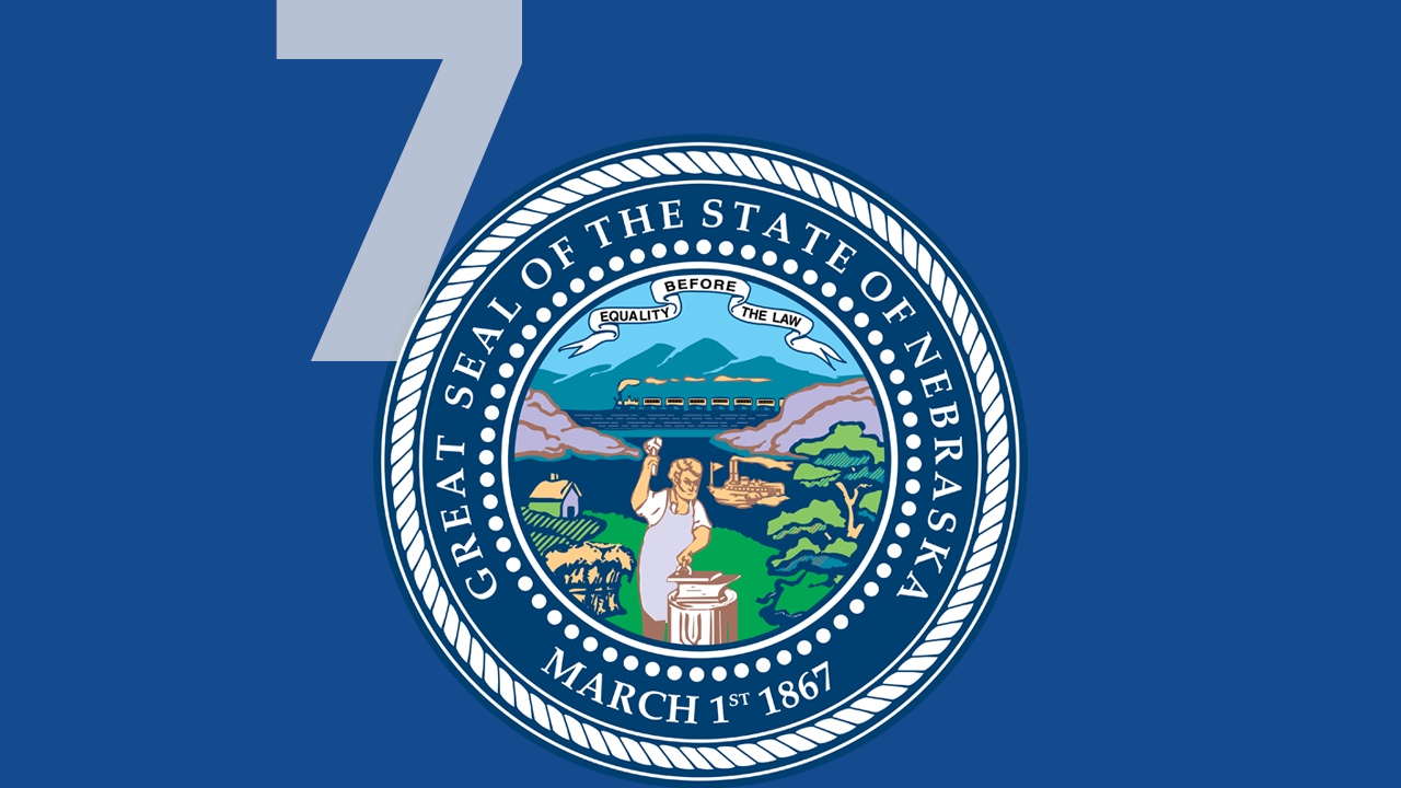 The Great Seal of the State of Nebraska centered on a blue background with a large white numeral seven.