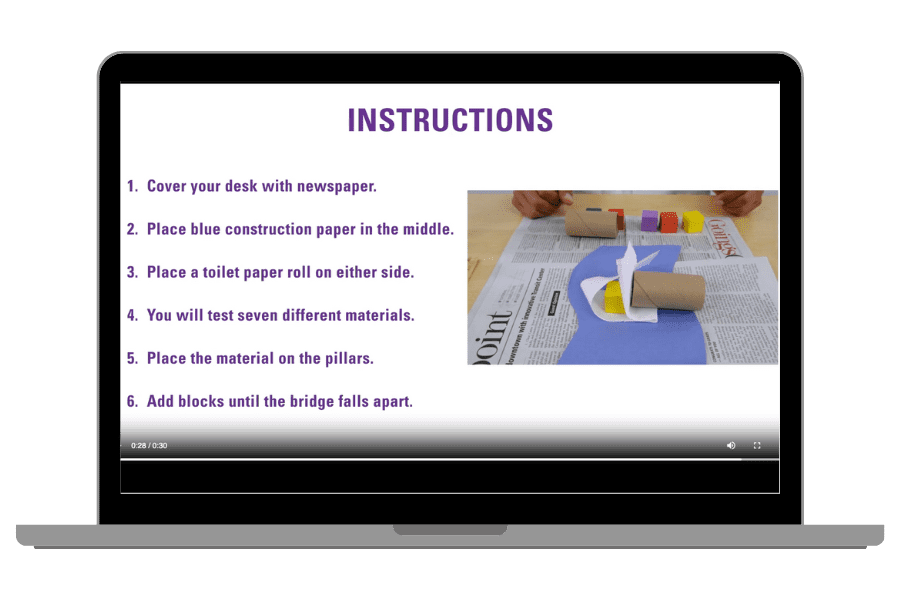 Laptop displaying bridge-building instructions and photo of a toilet paper roll bridge on newspaper.