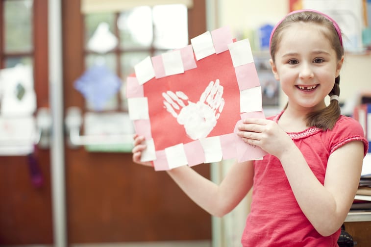 Little girl holding Valentine's Day Card