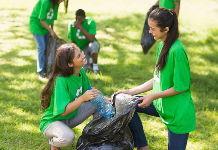 Team of volunteers picking up litter in park