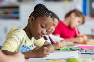 student drawing in a notebook