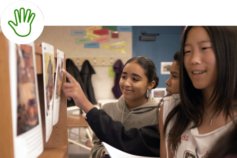 Students examine places on a bulletin board