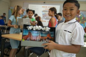Student holding a diorama